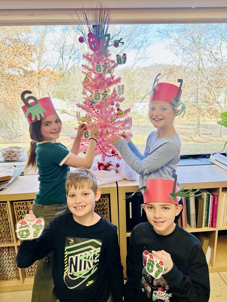students in front of 6-7 Christmas tree 