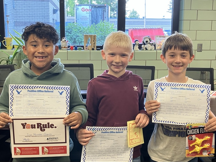 three boys standing in front of window with certificates 