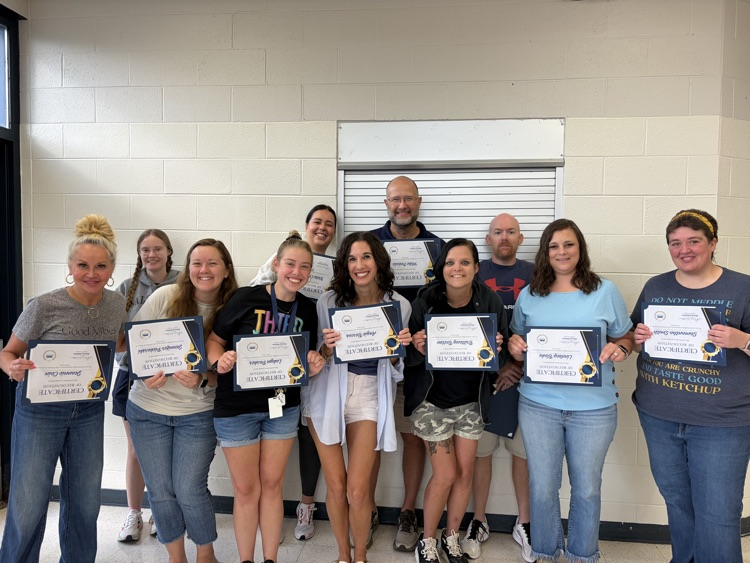11 adults holding certificates 