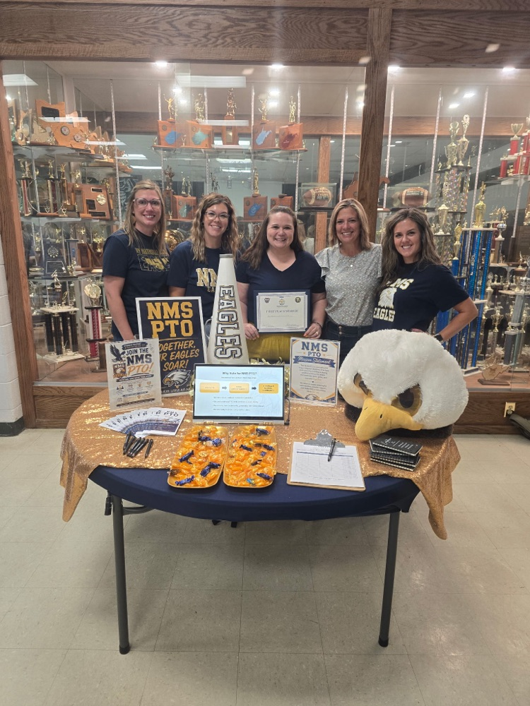 five ladies in front of a trophy case 