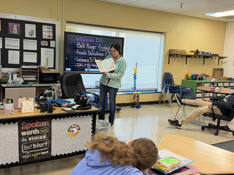Batton reading a book to her class 