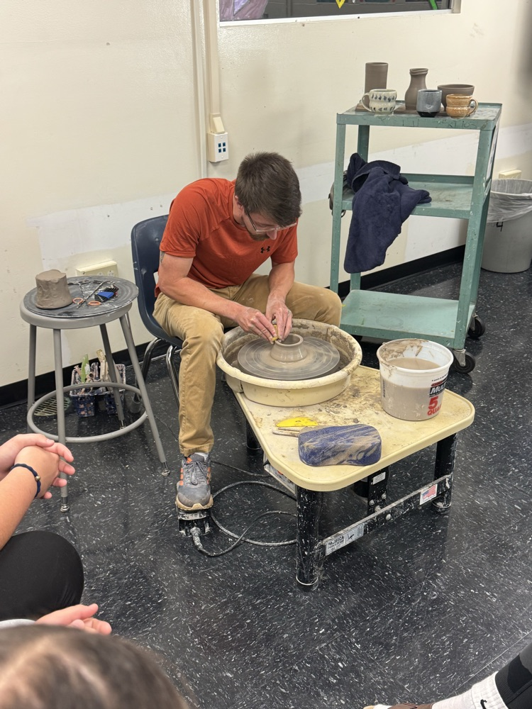 Jake Pierce showing how to throw a cylinder on the pottery wheel  