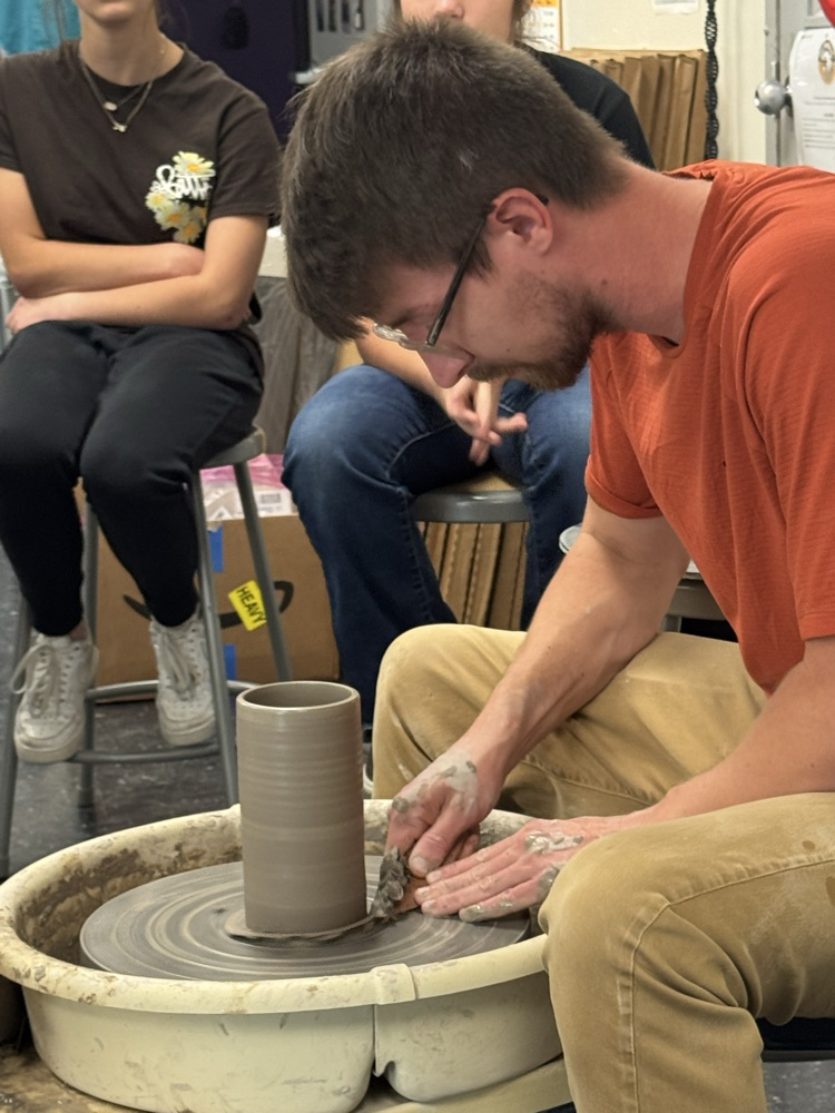 Jake Pierce demonstrates how to trim the base of a cylinder on the pottery wheel  