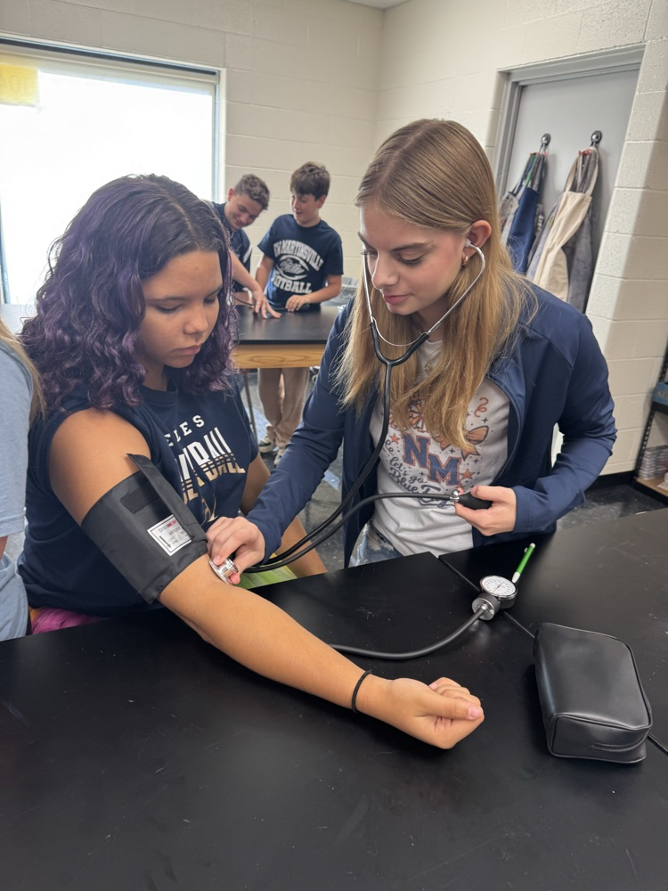 Jenna Moore taking Jasmine Evan’s blood pressure  