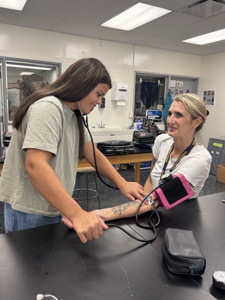 Kenleigh Robinson taking Mrs. Zwick’s blood pressure  