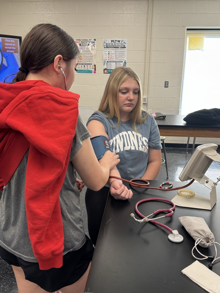 Gigi Frink taking Brooklynn Williams blood pressure  