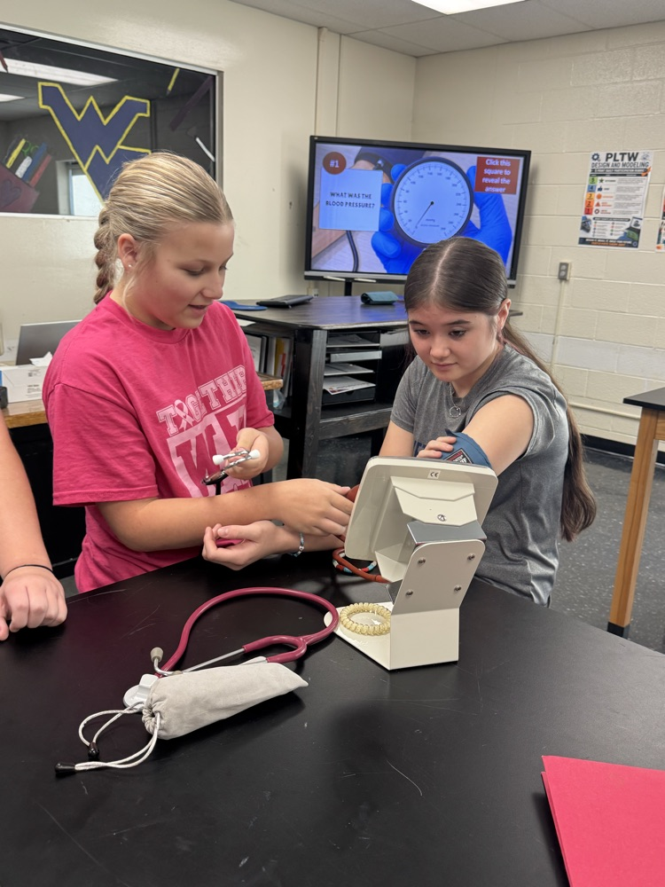 Gracie Bosley taking Gigi Frinks blood pressure  