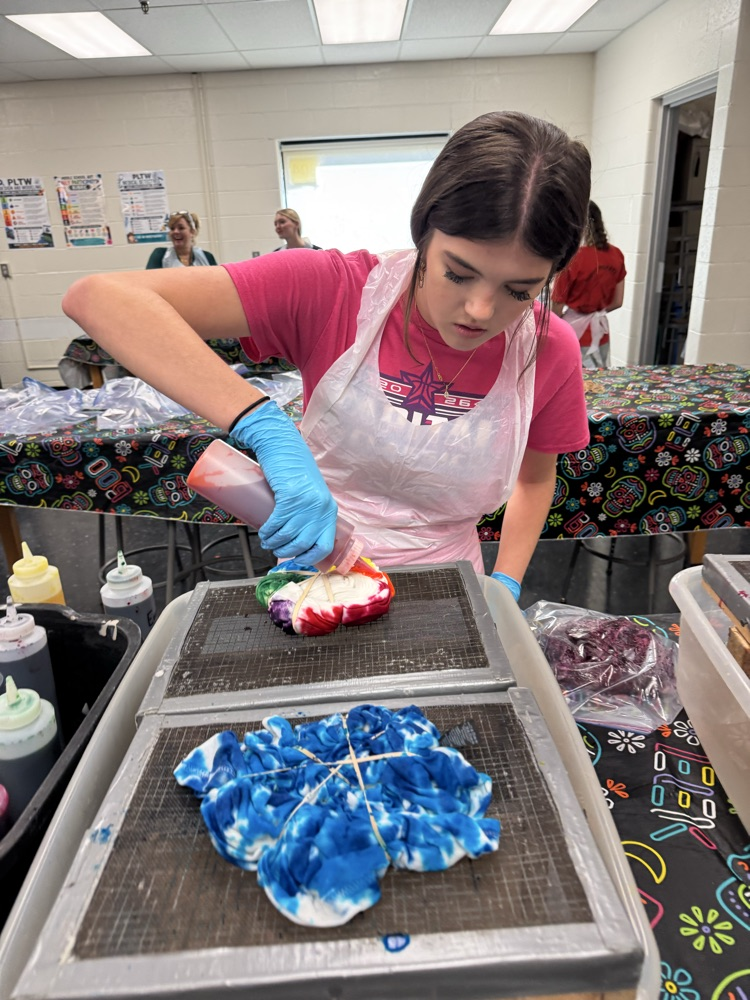 Ava Goddard applying dye to her shirt. 