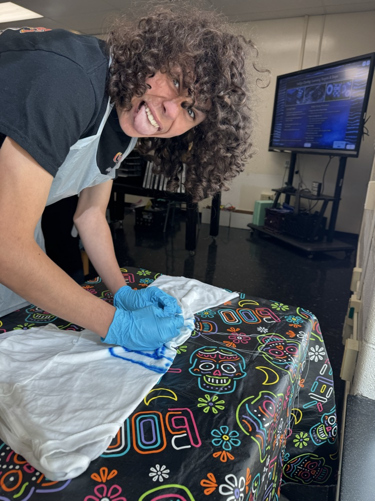 Paxton Hale works on his design for his shirt  