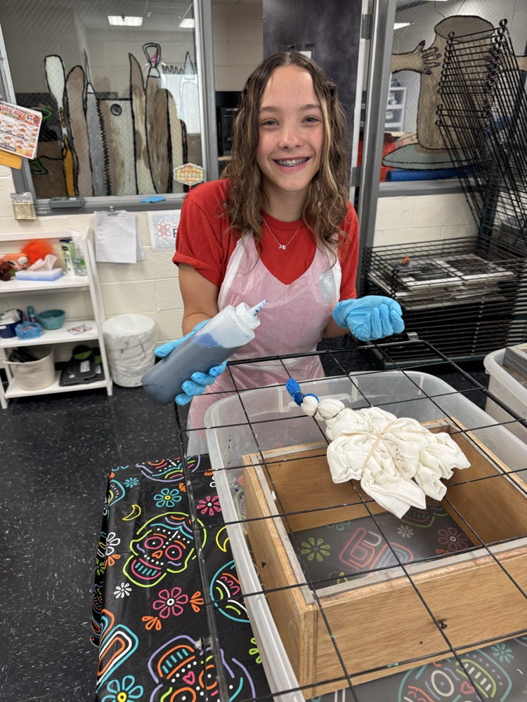 Nora Goddard applying dye to her shirt. 