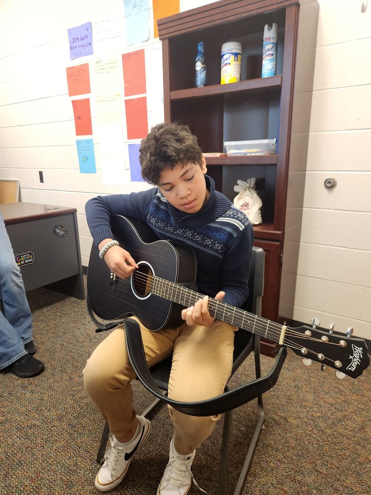 7th grade student playing guitar