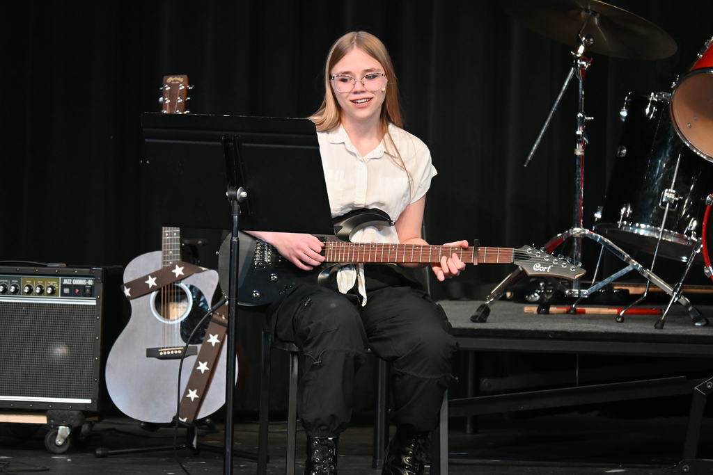 Student playing guitar during the pops concert 