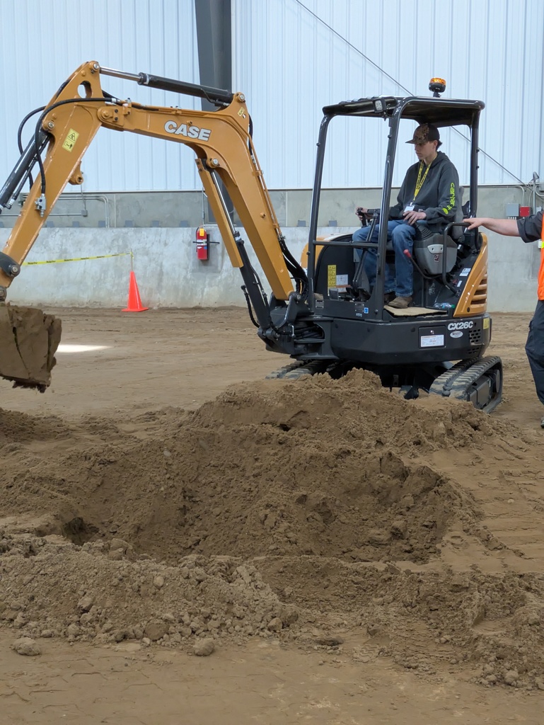 Student gets a hands-on experience with the machinery and help from the operator 