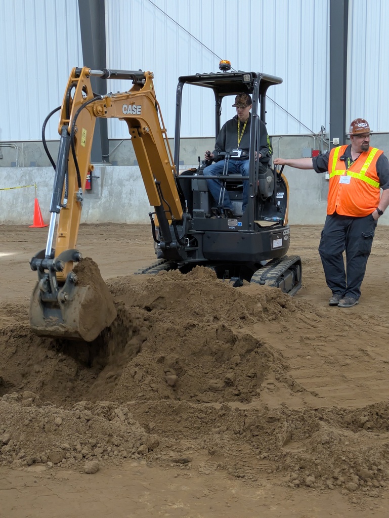 Student gets a hands-on experience with the machinery and help from the operator 
