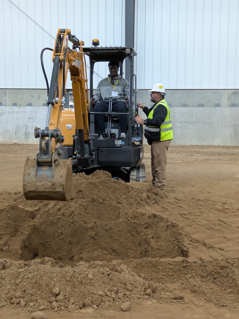 Student gets a hands-on experience with the machinery and help from the operator 