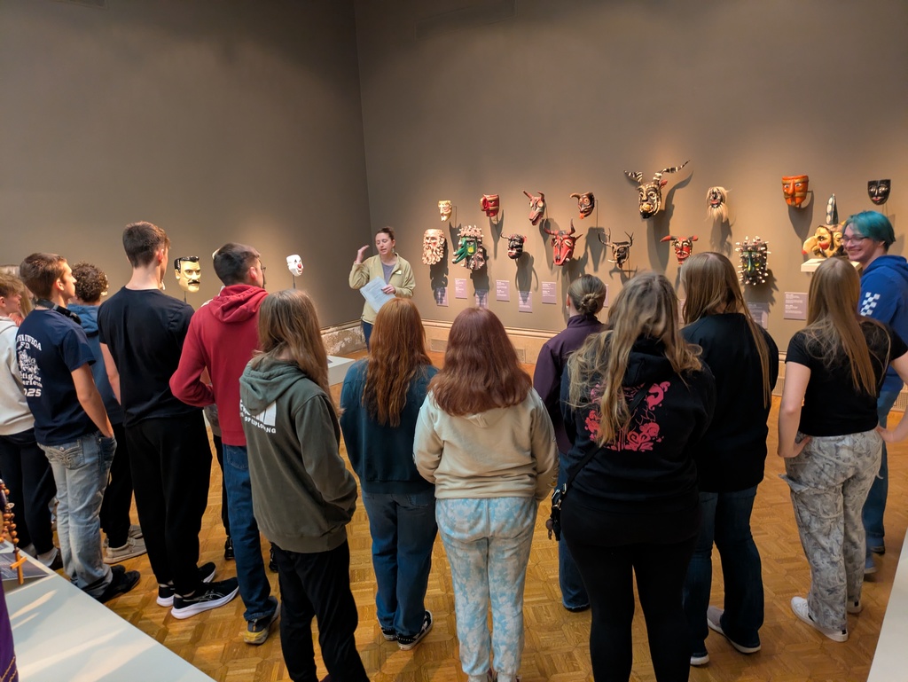 Students learning from the guide all about the different masks 