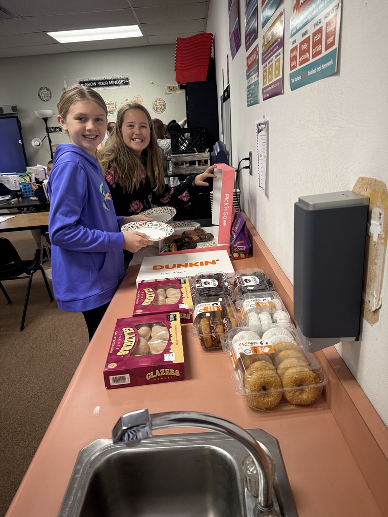Students with big smiles as they pick out their favorite donuts to celebrate solving some tough math problems 
