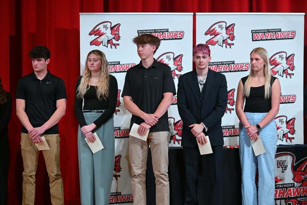 Five students pose for a picture on senior award night