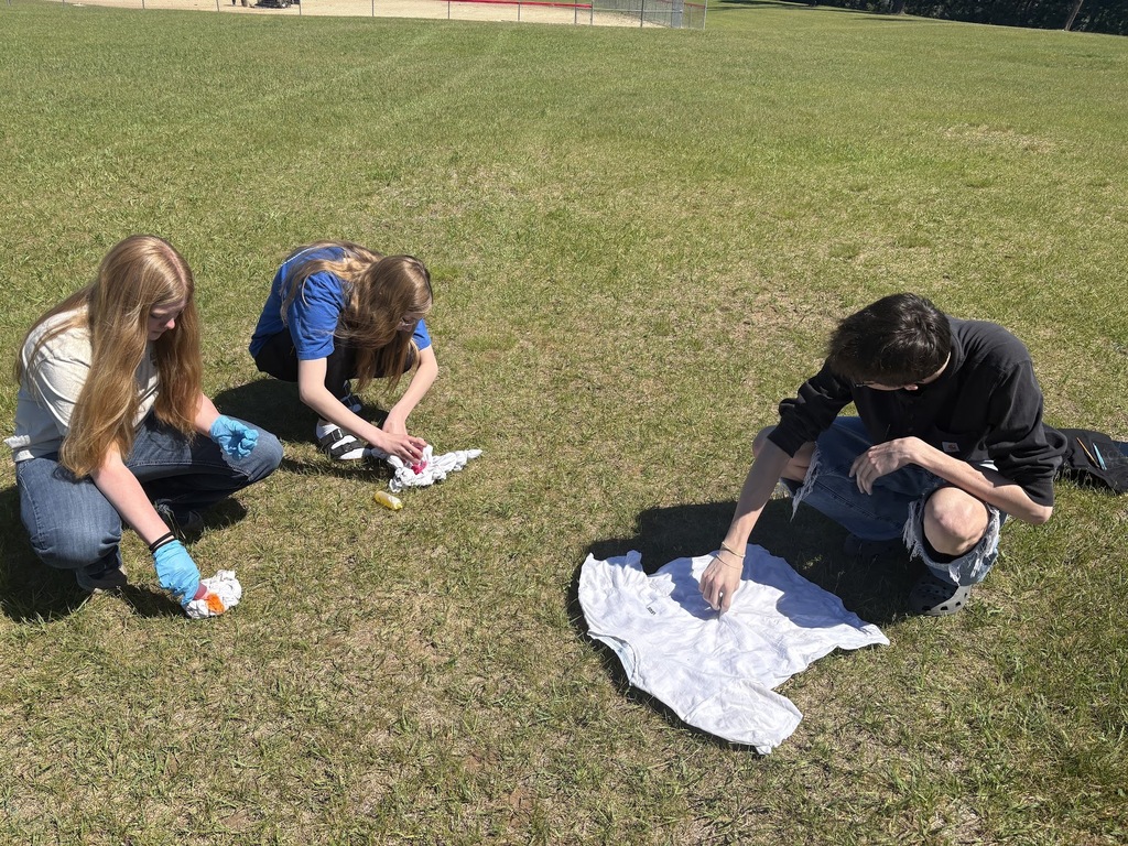 Students working on traditional tie-dye outside.