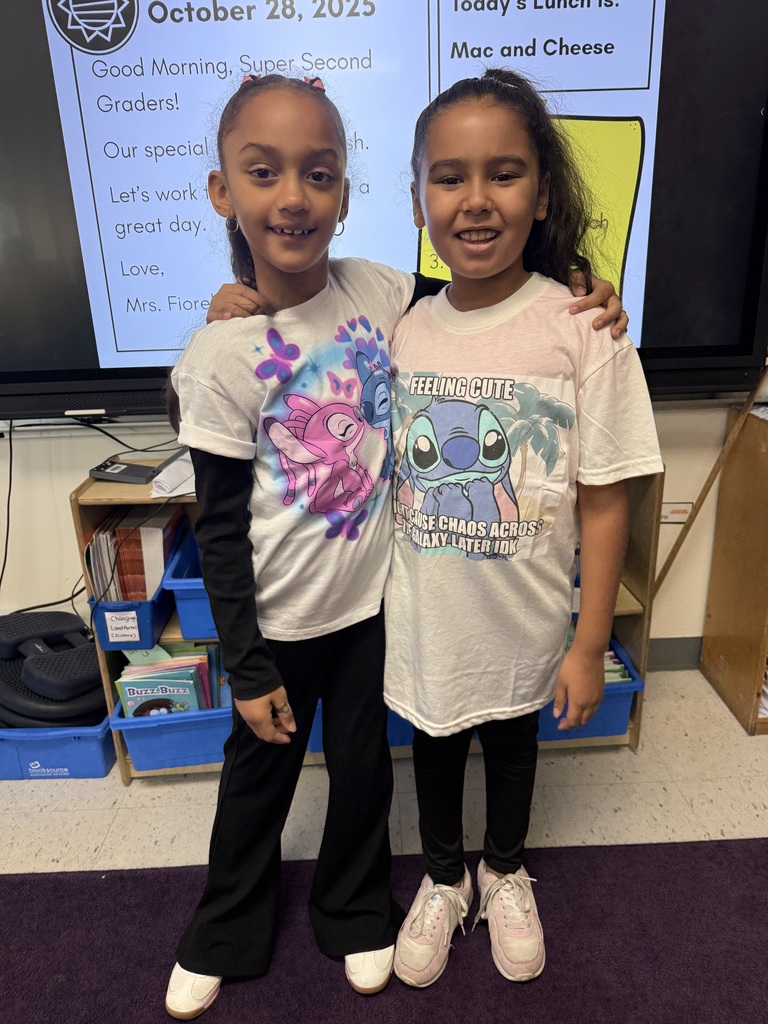 Two girls wearing matching shirts