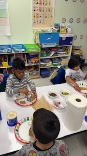 kids making gingerbread houses