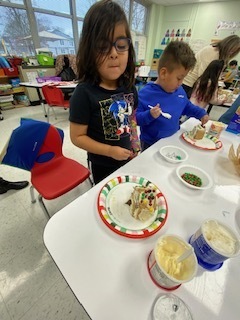 kids making gingerbread houses