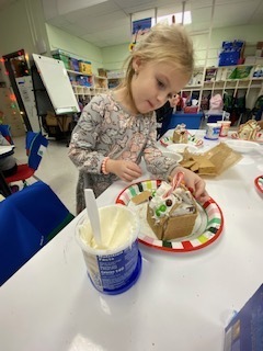 kids making gingerbread houses