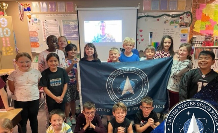 Stem to Space 2025: Group of young students holding a US Space Force Flag