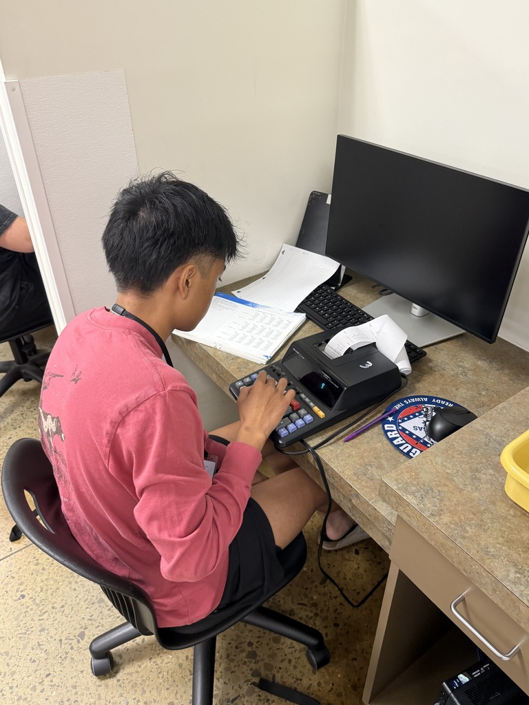 Principles of Banking student using 10-key calculator