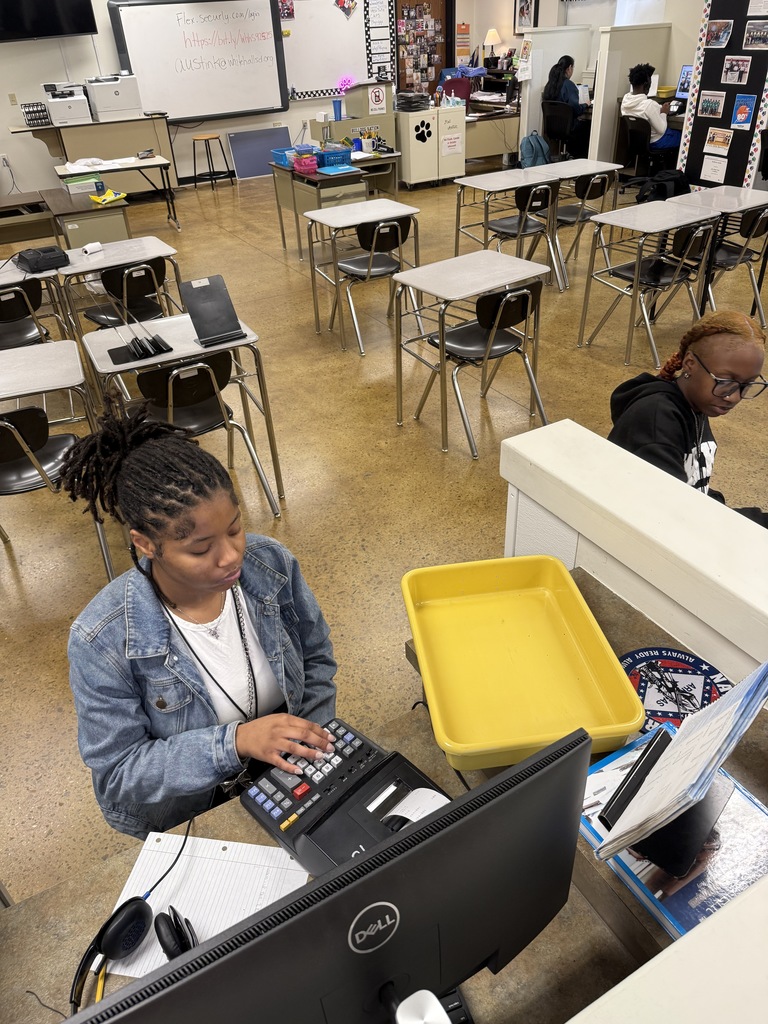 Principles of Banking student using 10-key calculator