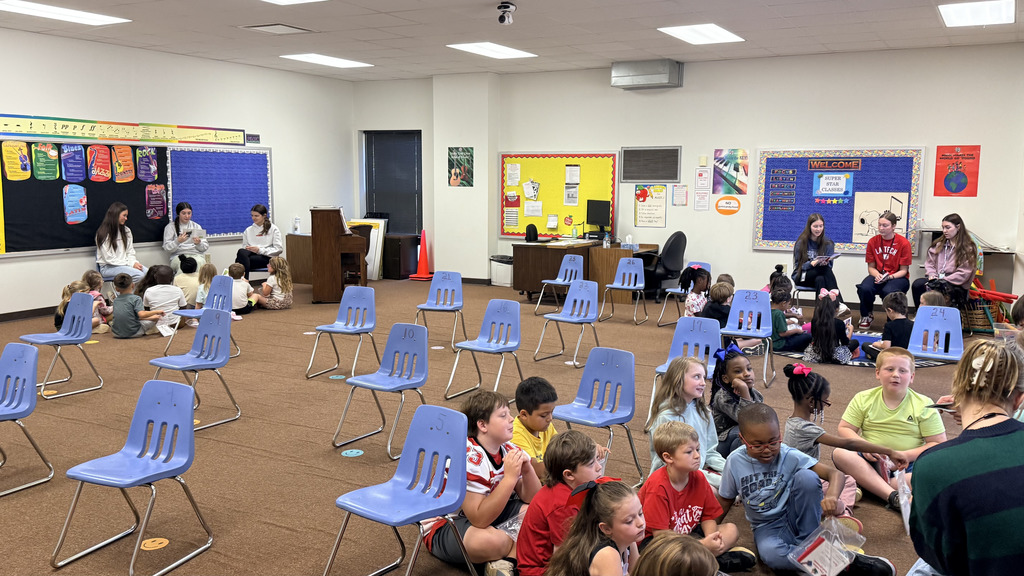 pictures from The WHHS Chick-fil-A Leader Academy service project, donating books to students and reading books
