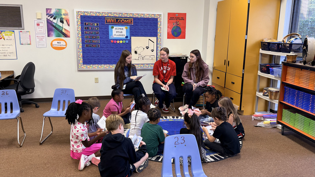 pictures from The WHHS Chick-fil-A Leader Academy service project, donating books to students and reading books