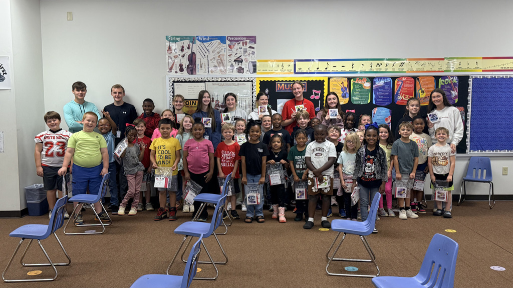 pictures from The WHHS Chick-fil-A Leader Academy service project, donating books to students and reading books