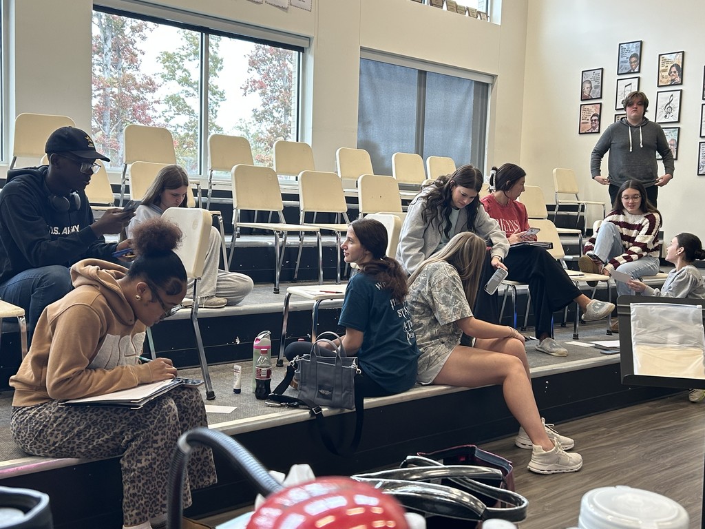 Chamber Singers work hard writing toasts for their upcoming Madrigal FeastpPerformance.