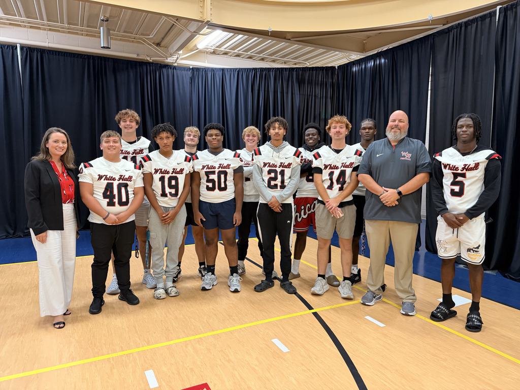 Senior members of the football team with Principal Jennifer Menard and Coach Jason Mitchell