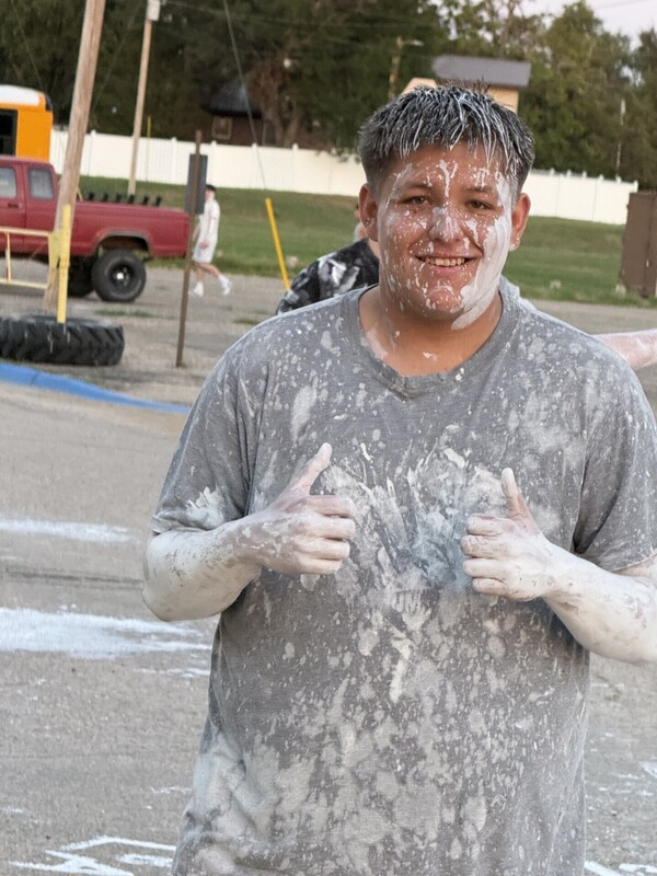 High School students covered in white paint