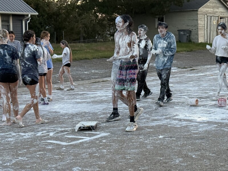 High School students covered in white paint