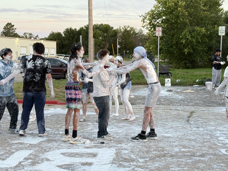 High School students covered in white paint
