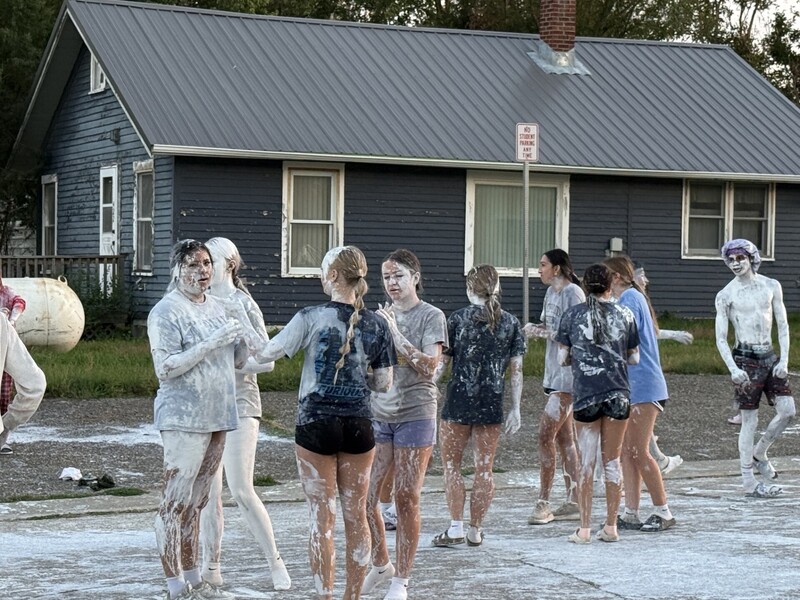 High School students covered in white paint