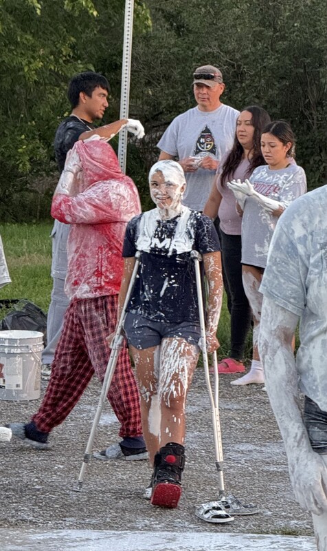 High School students covered in white paint