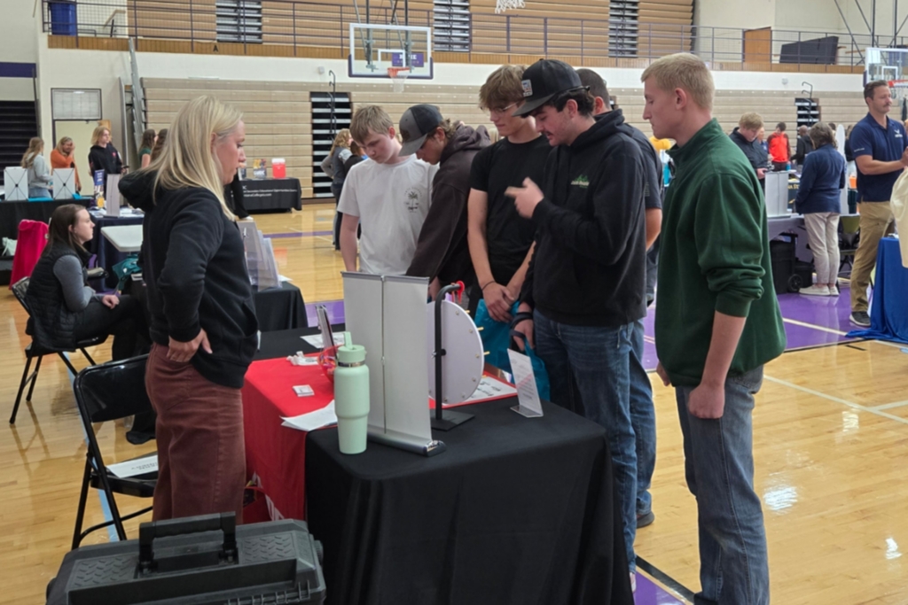 Students visiting with a booth at the College and Career Fair.
