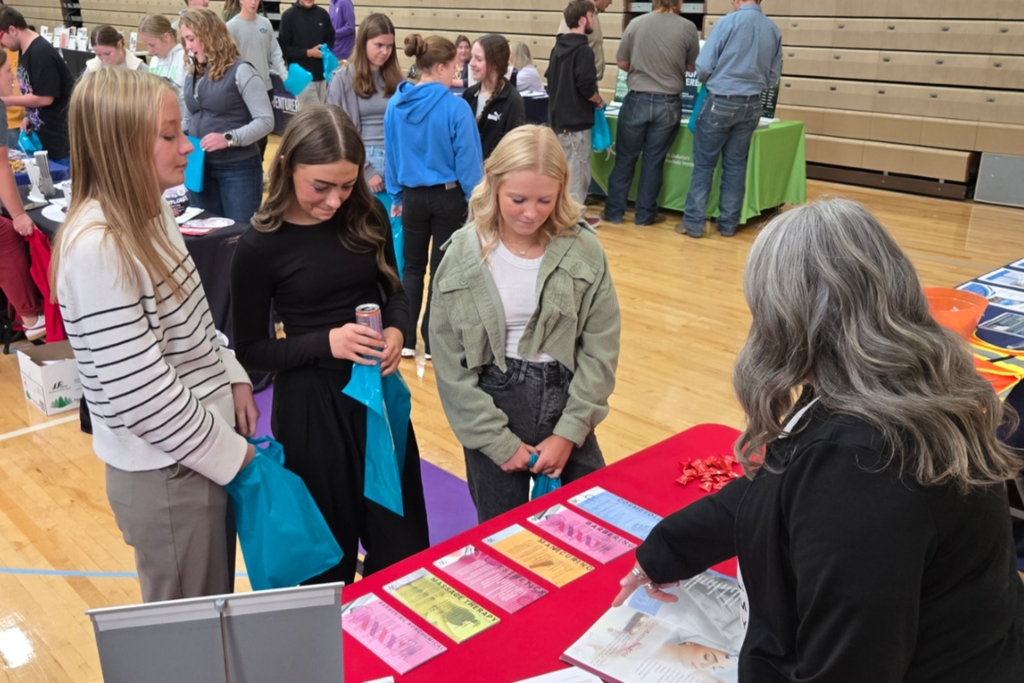 Students visiting with a booth at the College and Career Fair.
