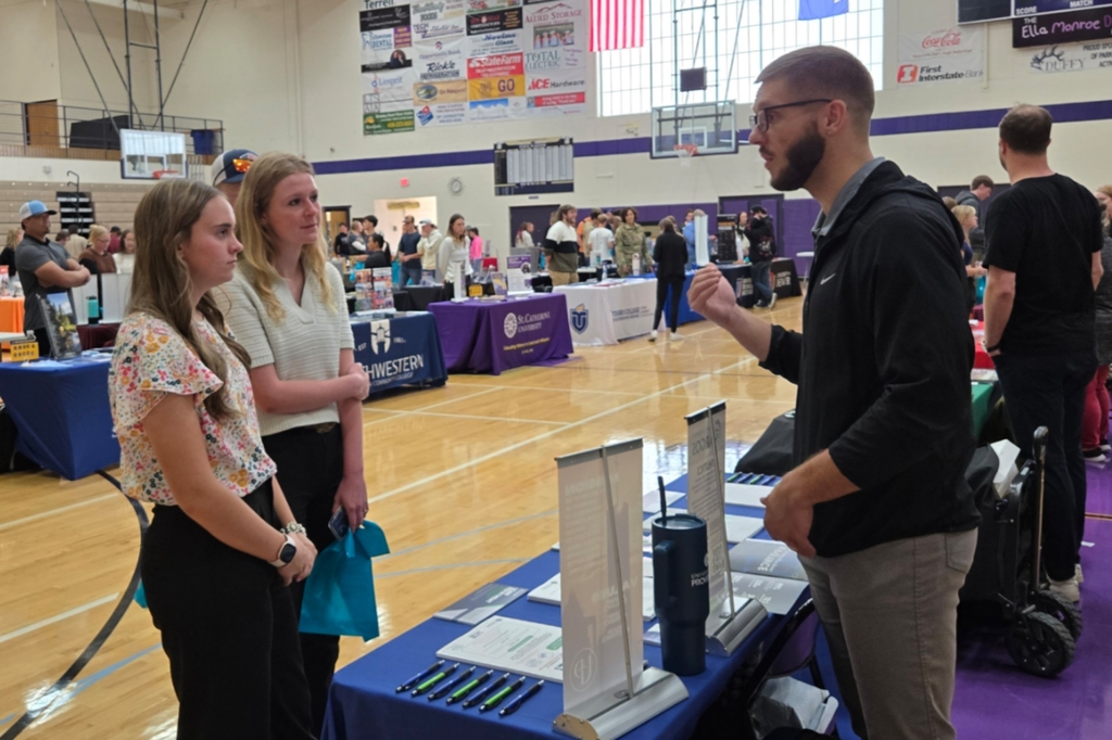 Students visiting with a booth at the College and Career Fair.