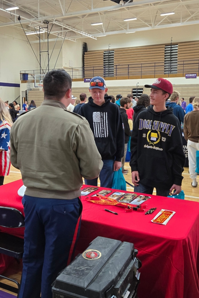 Students visiting with a booth at the College and Career Fair.