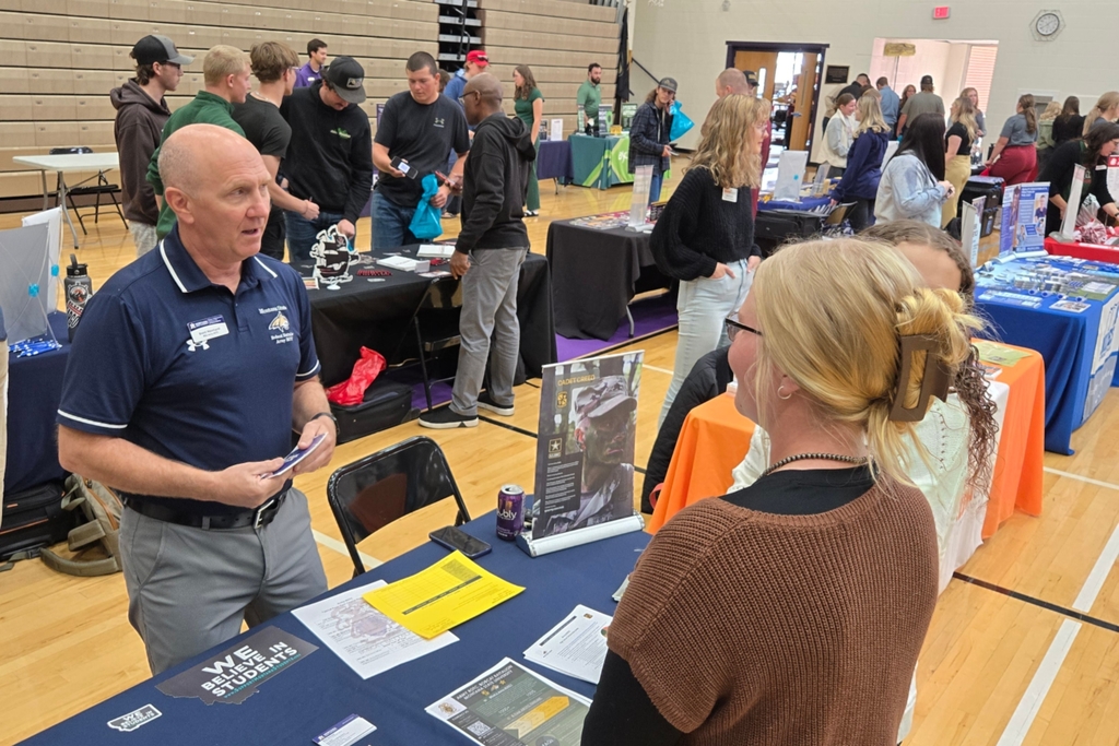 Students visiting with a booth at the College and Career Fair.
