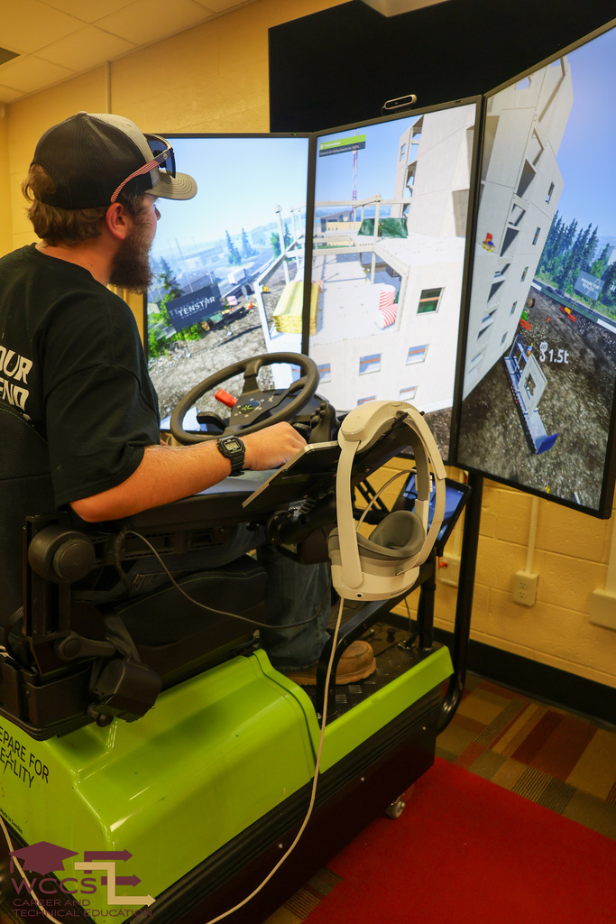 Colton G. operates the crane operator simulator.