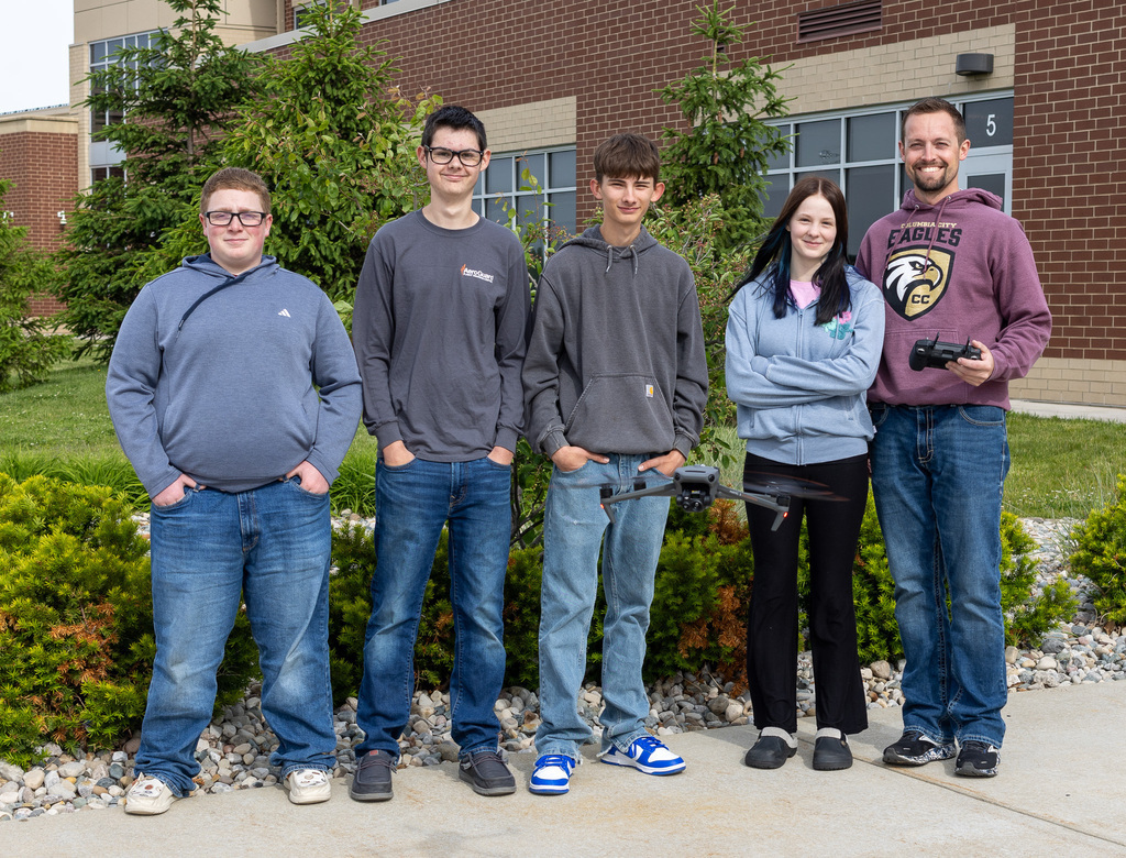 Students and Mr. Campbell stand with students.