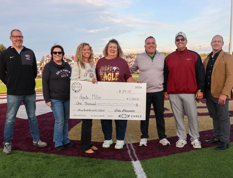 WCCS and City Chevy officials celebrate Angela Miller and Chris Bechtold.