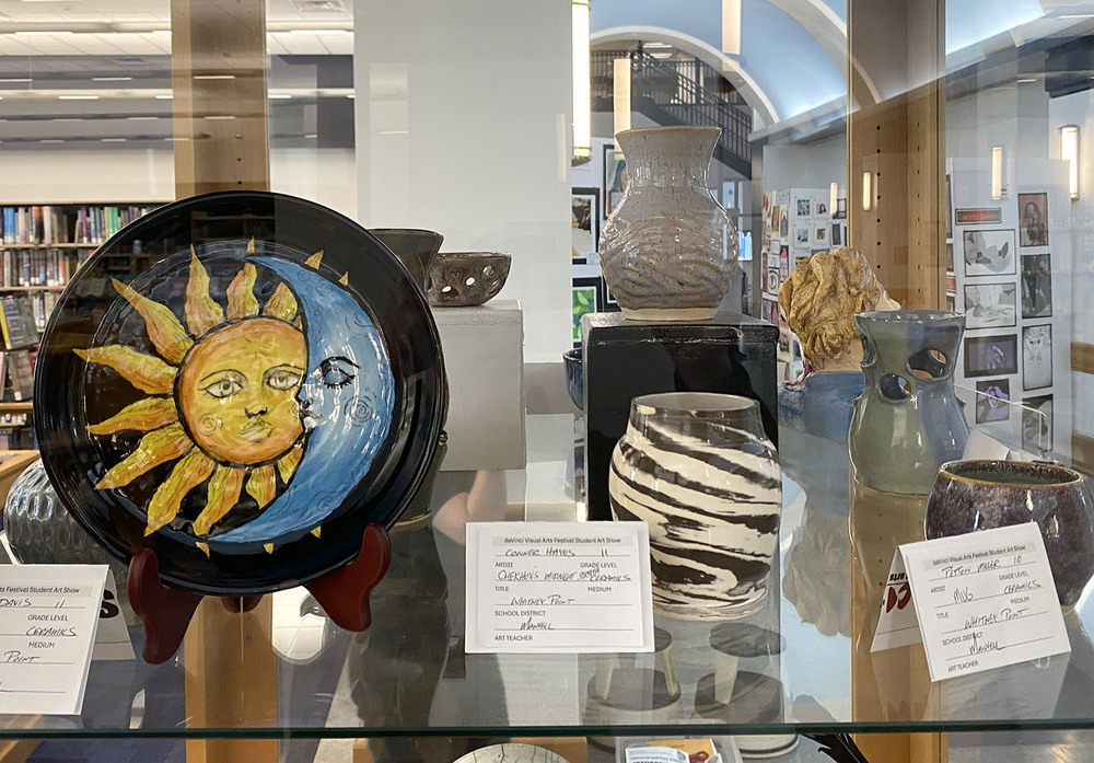 Ceramic artwork by Whitney Point High School students is displayed in a case at the Broome County Public Library as part of the DaVinci Student Art Show.