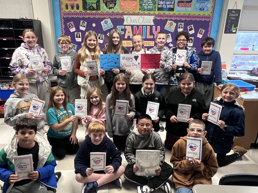 Mrs. Zabadal fifth graders hold the Veterans Day cards they made for veterans at the American Legion.